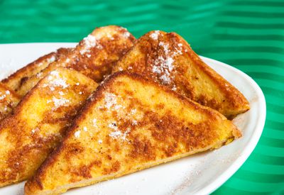 Plate of French toast. Five slices of French toast sit on a...