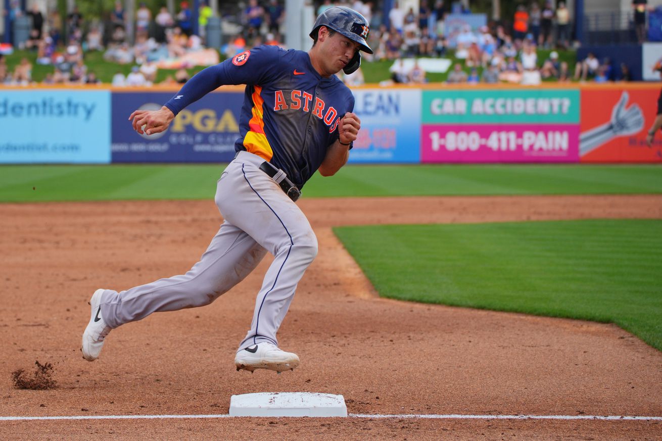 Shay Whitcomb rounding third during a spring training game