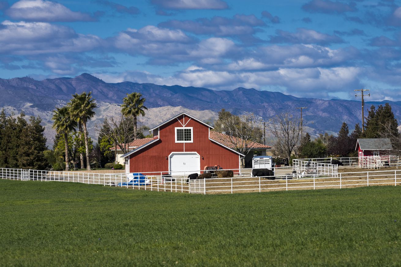 Red Barn and Palm Trees surrounded by mountains, Central California