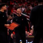 Nov 22, 2024; Houston, Texas, USA; Houston Rockets head coach Ime Udoka smiles during a timeout against the Portland Trailblazers during the third quarter at Toyota Center. Mandatory Credit: Erik Williams-Imagn Images