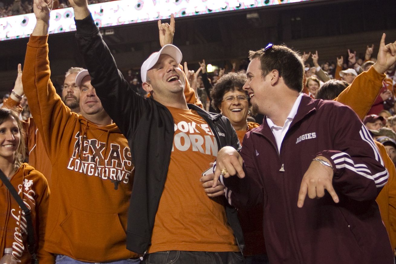 Sports: UT fans put their horns up while Texas A&M fan puts his horns down as they get ready for the start of the UT-A&M game