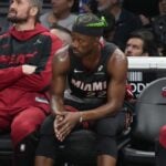 Jan 2, 2025; Miami, Florida, USA; Miami Heat forward Jimmy Butler (22) looks on from the bench during the second half at Kaseya Center.