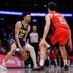 Jan 15, 2025; Denver, Colorado, USA; Denver Nuggets guard Trey Alexander (23) controls the ball against Houston Rockets guard Reed Sheppard (15) in the fourth quarter at Ball Arena.